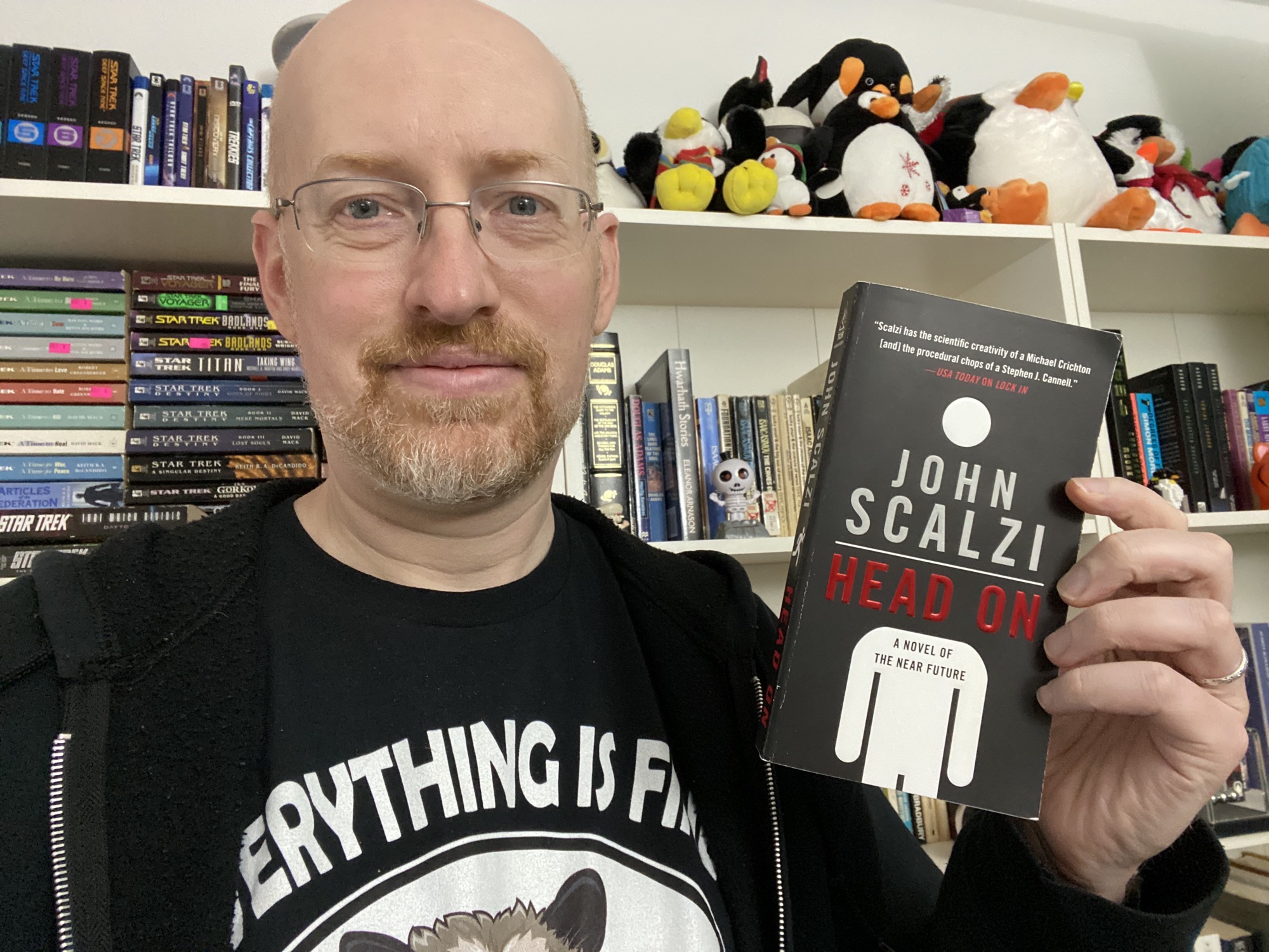 Photo of Michael Hanscom holding the book _Head On_ by John Scalzi