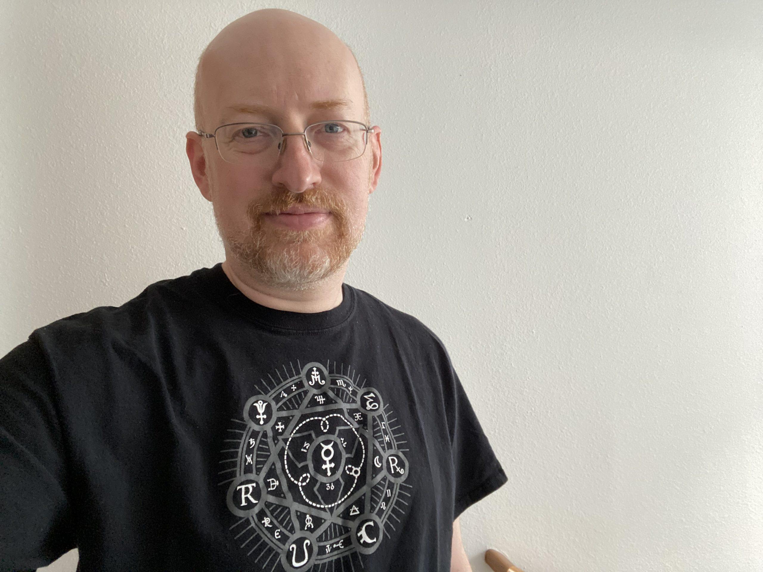 Me wearing a black t-shirt from local Seattle area goth club The Mercury. The design looks like a magic protective sigil.