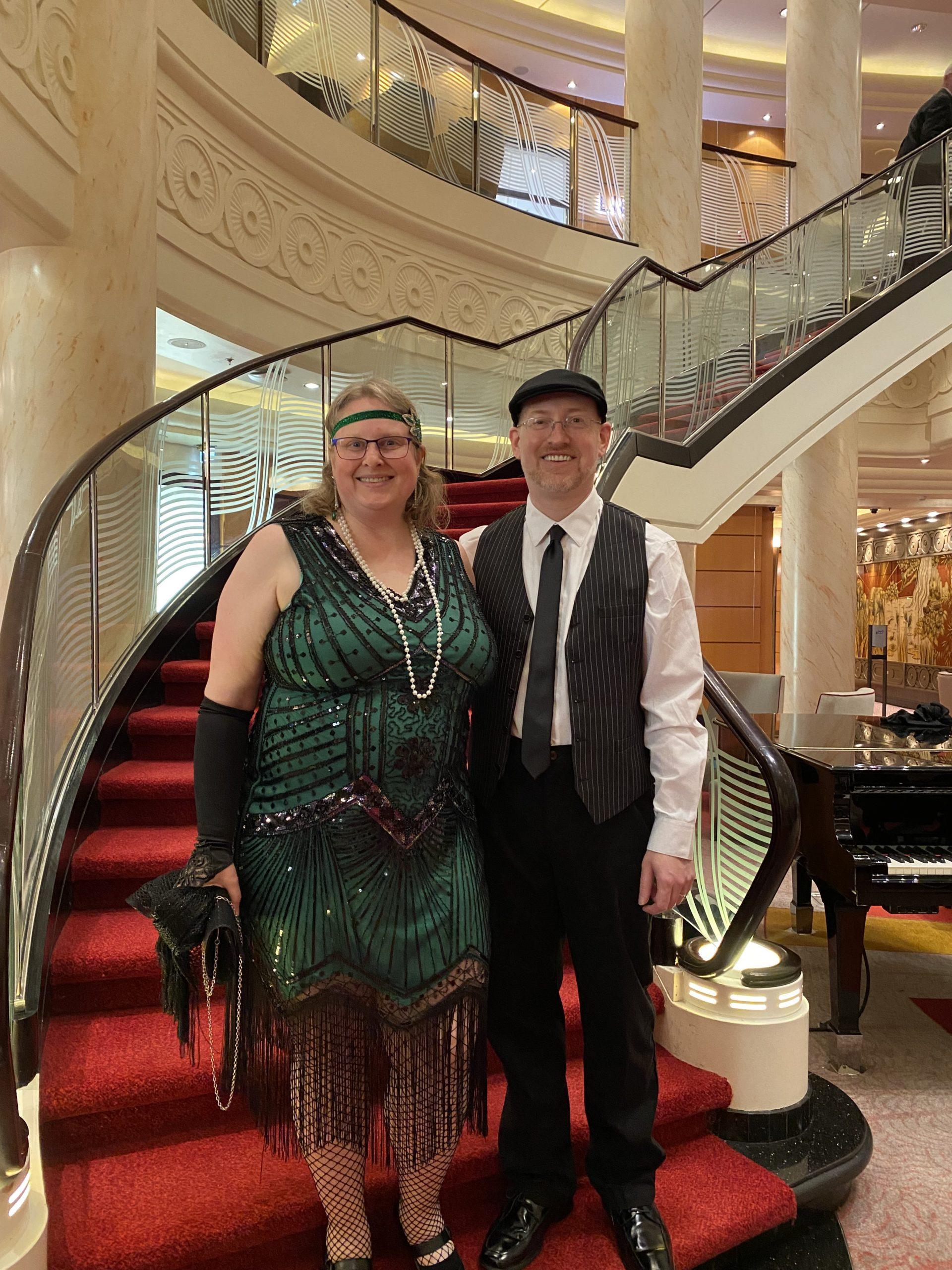 My wife and I in our 1920s costumes standing at the base of the ship's grand staircase.