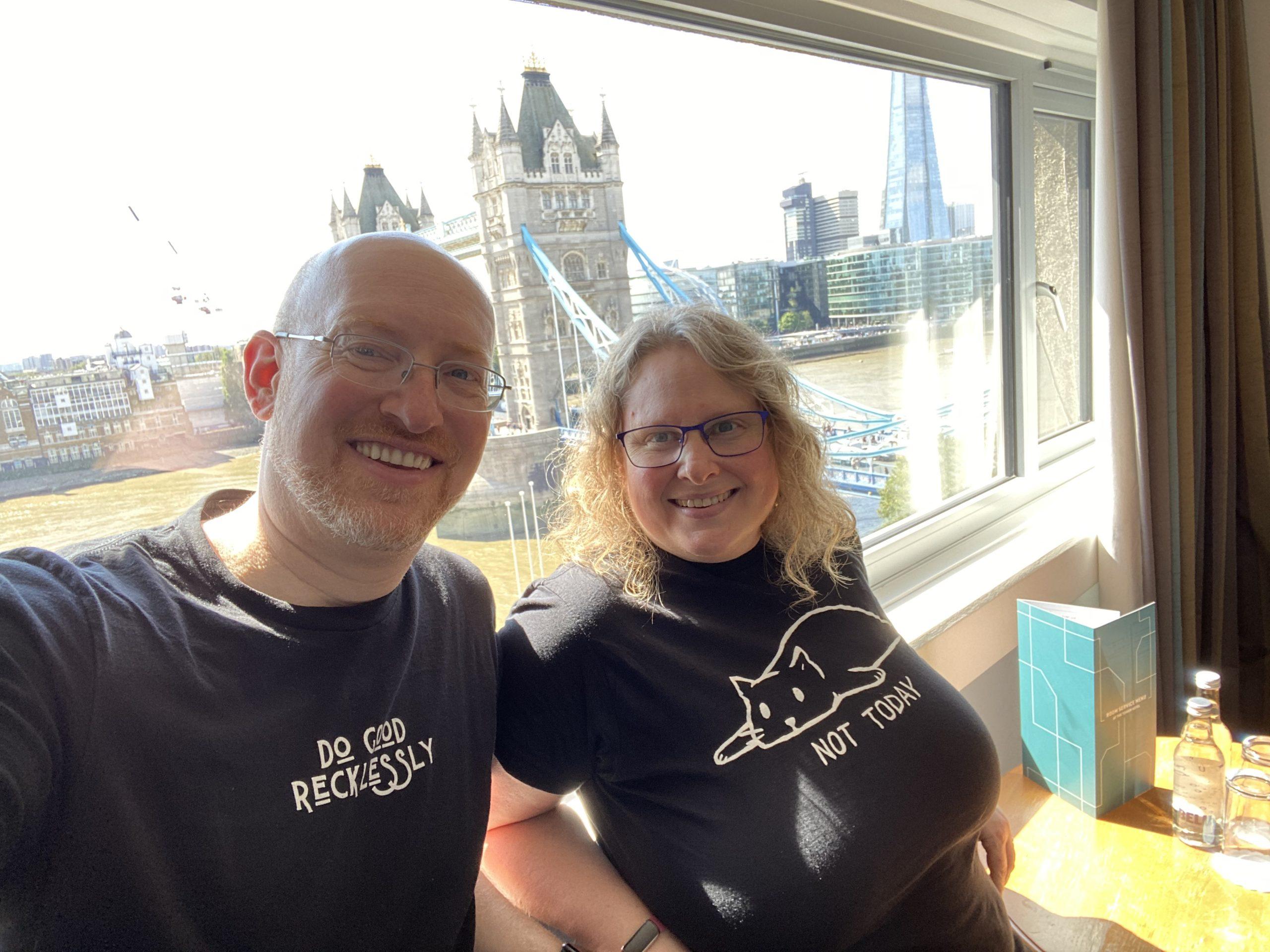 My wife and I in front of the window of our hotel room in London. Behind us is a gorgeous view of Tower Bridge.