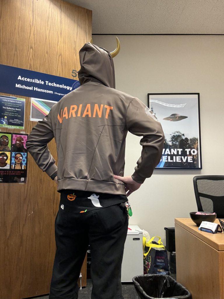 Me with my back to the camera, showing the orange all-caps VARIANT label on the back of the hoodie.