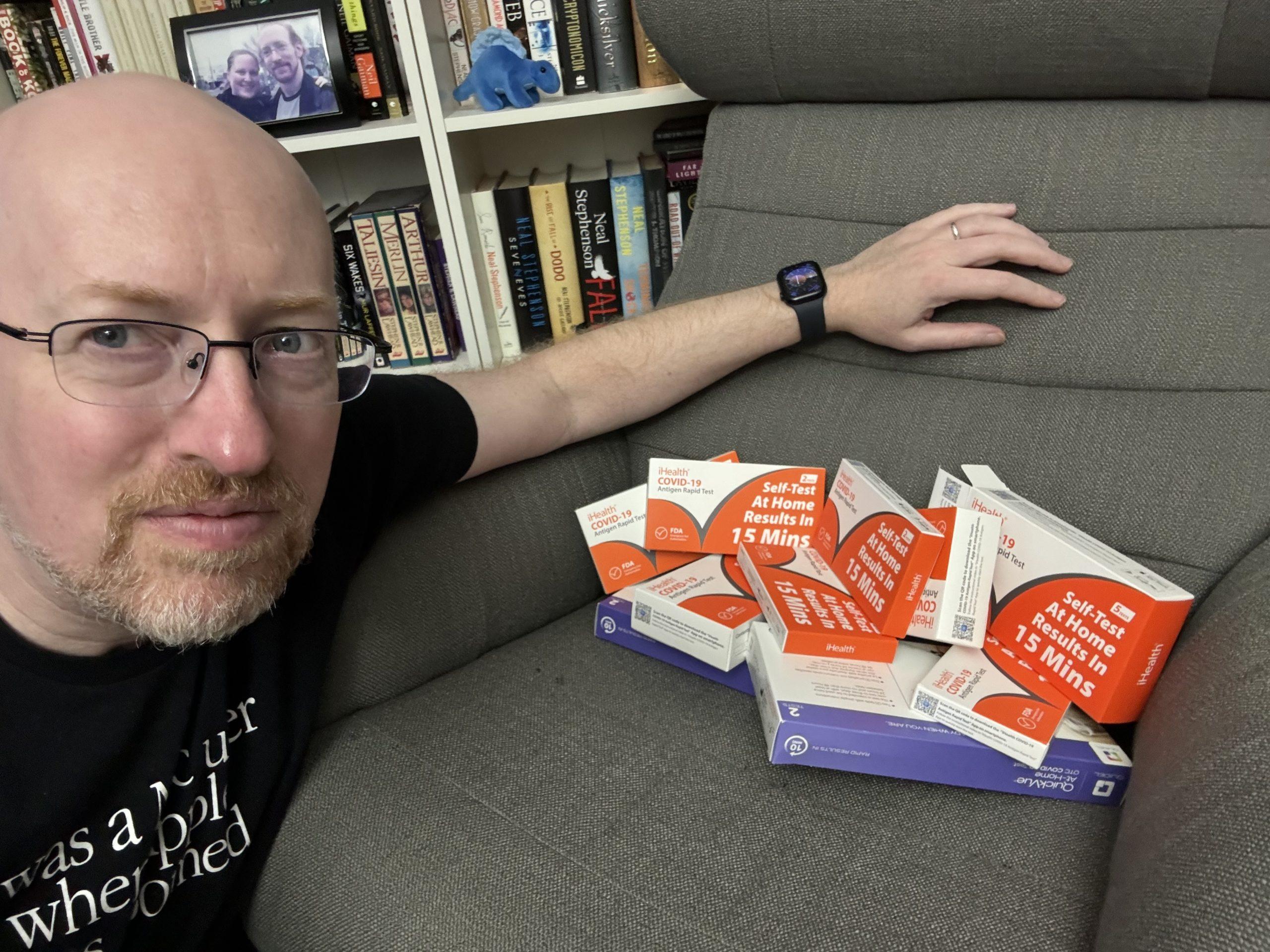 Me with a pile of expired COVID-19 home tests.