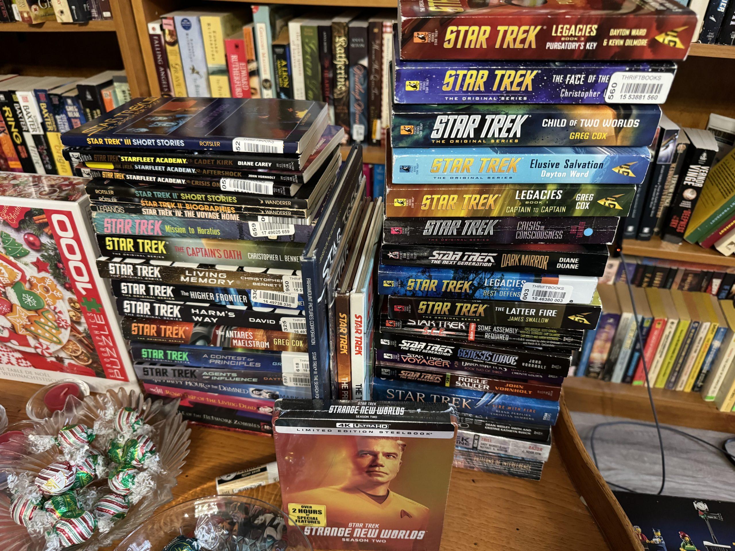 A large stack (approximately 40) of mostly Star Trek books, primarily but not entirely TOS.