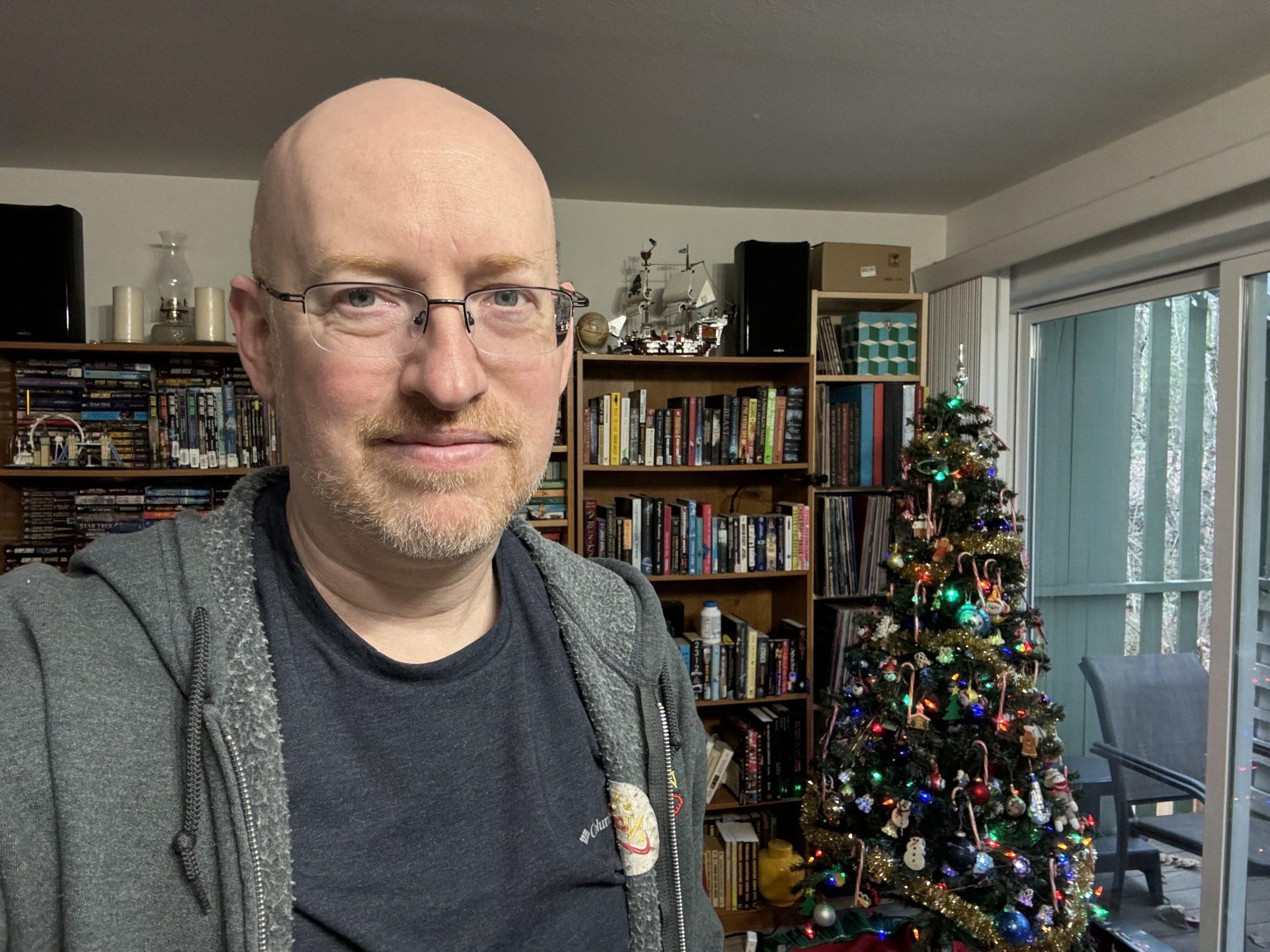 Me standing in our living room with a somewhat tired, resigned expression.