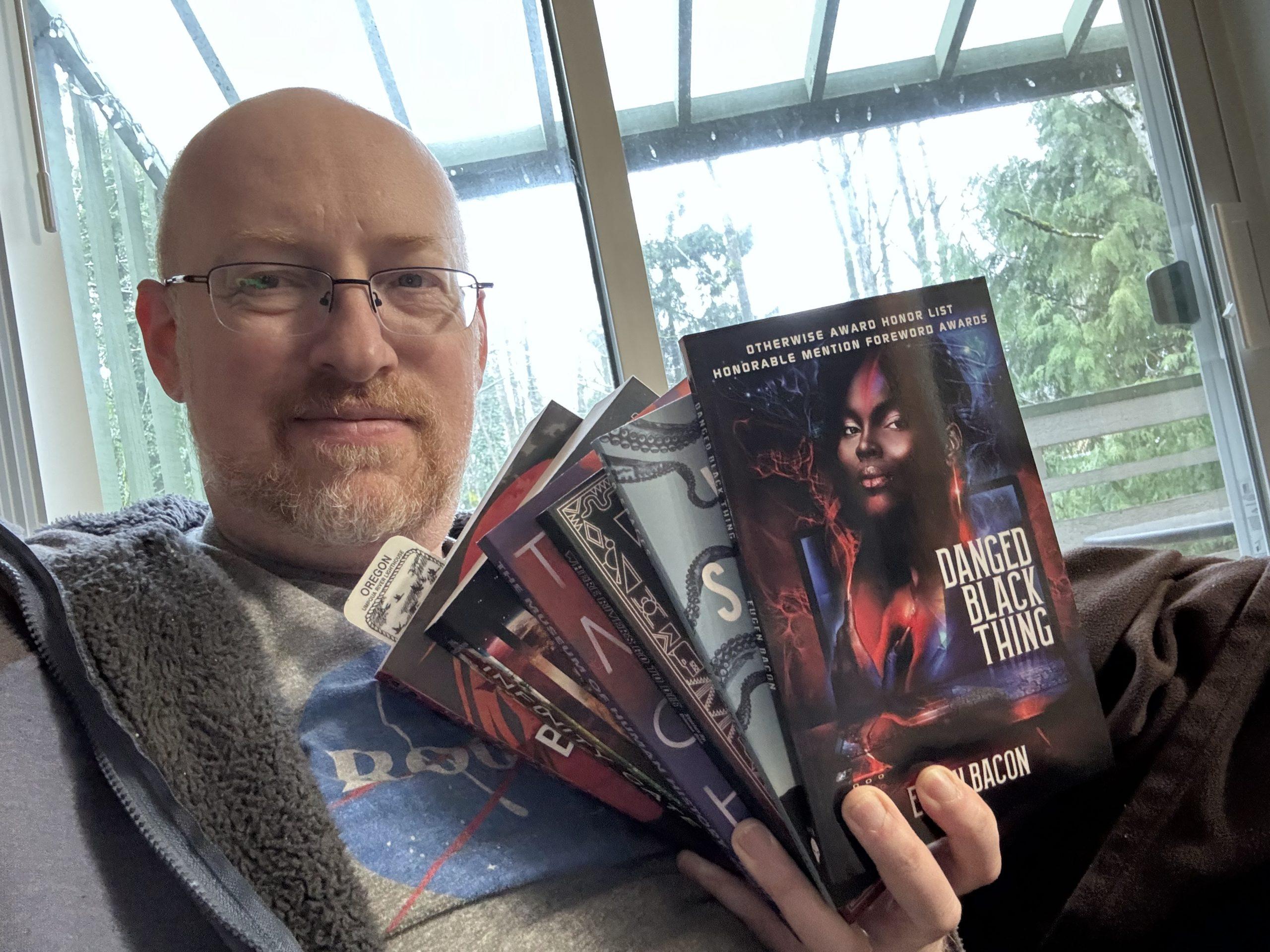 Me holding all six of this year's Philip K. Dick Award nominated books.