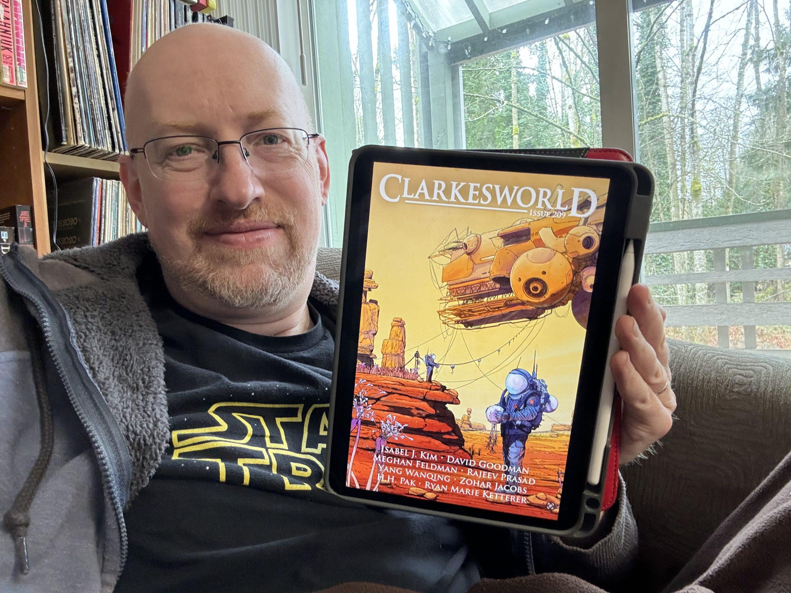 Me holding Clarkesworld 209 on my iPad
