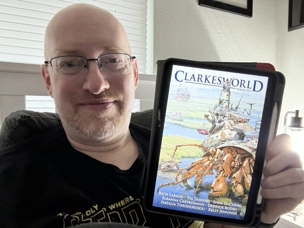 Me holding Clarkesworld 211 on my iPad.
