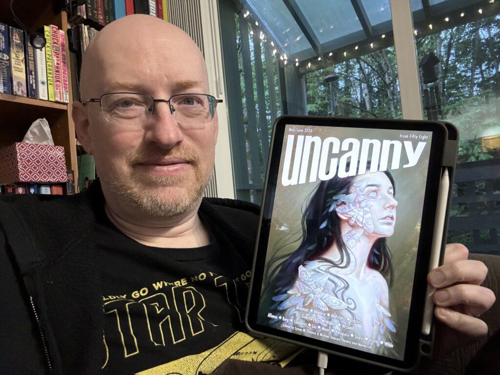 Me holding Uncanny Magazine issue 58 on my iPad