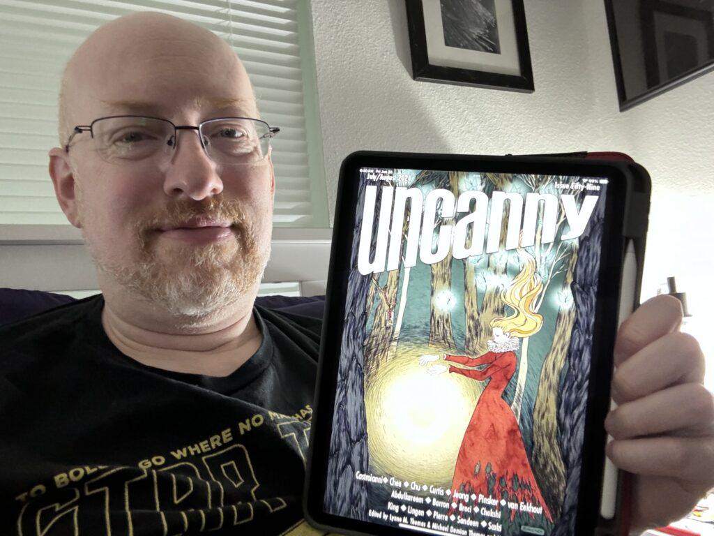 Me holding my iPad with Uncanny issue 59