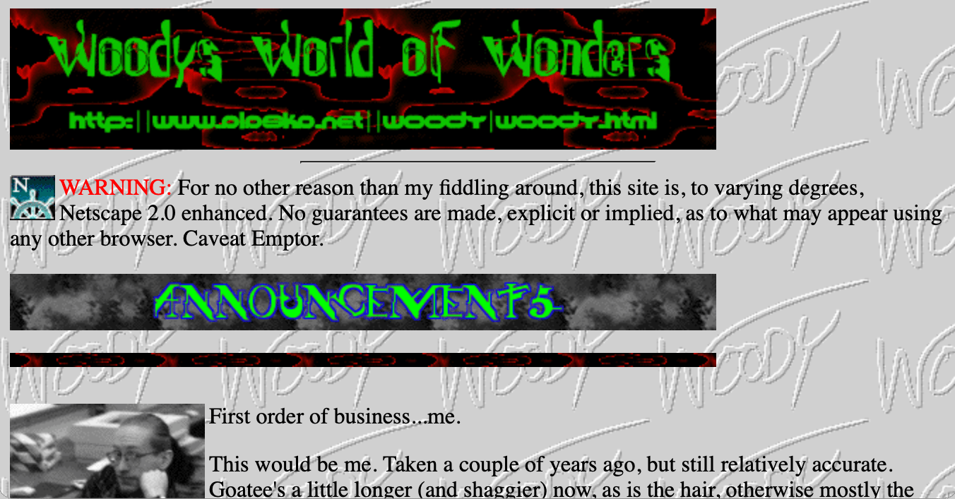 Screenshot of my 1996 website, titled 'Woody's World of Wonders'. It has a repeating gif background of my signature, and a 'Netscape 2.0 enhanced' warning at the top.