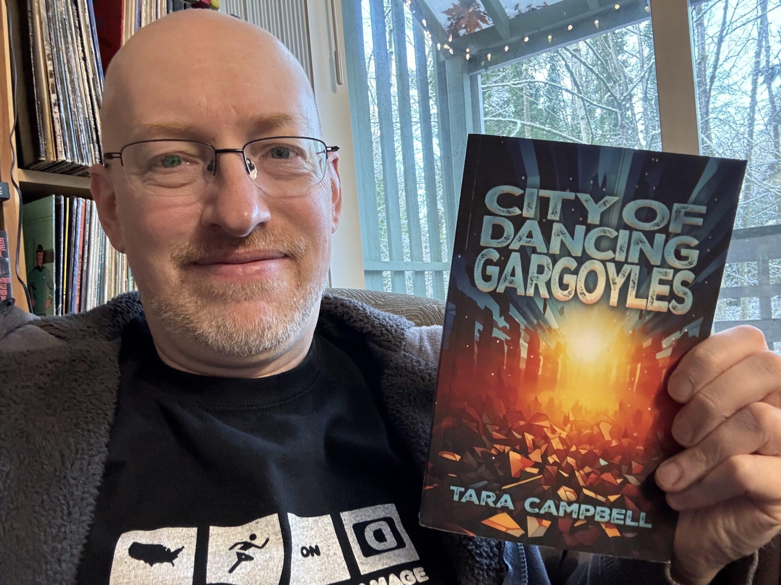 Me holding City of Dancing Gargoyles.