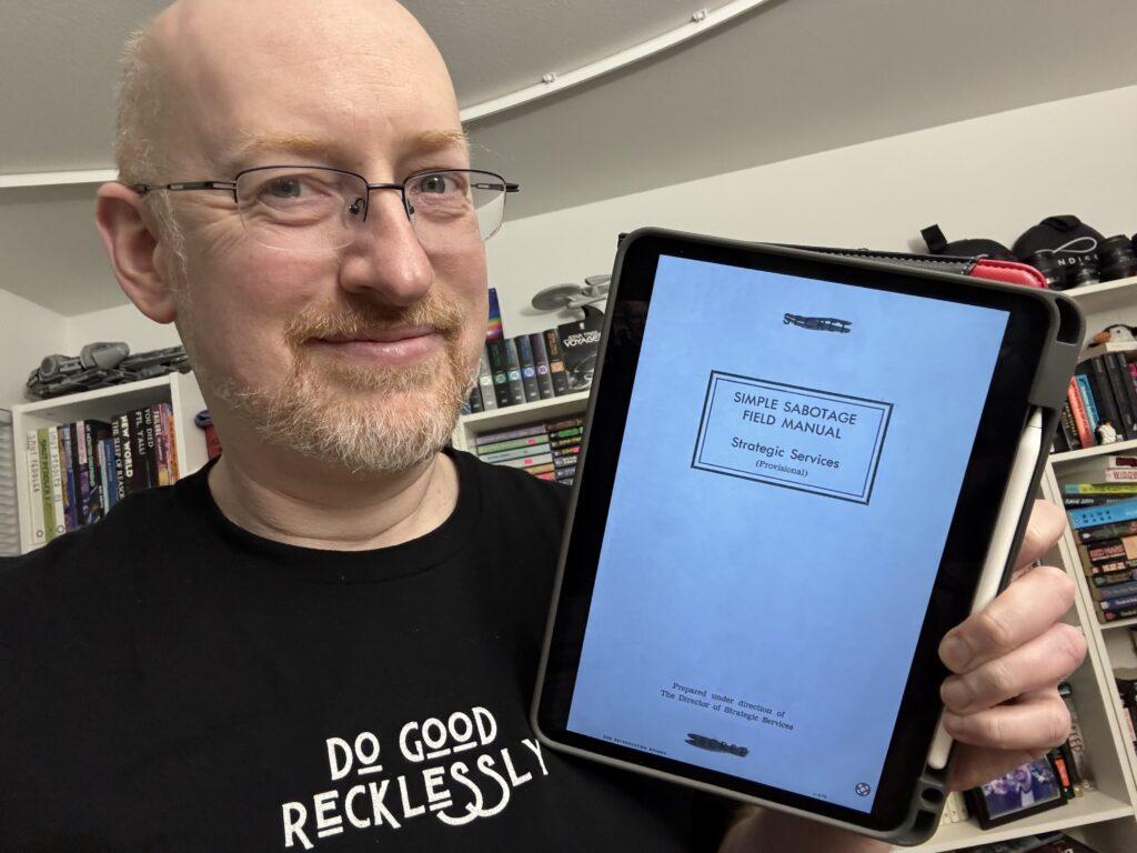 Me holding the Simple Sabotage Field Manual on my iPad