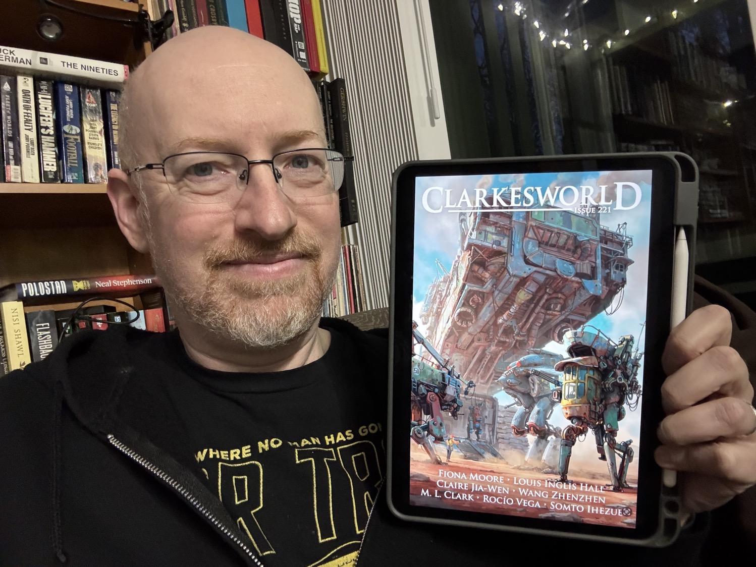 Me holding Clarkesworld 221 on my iPad.