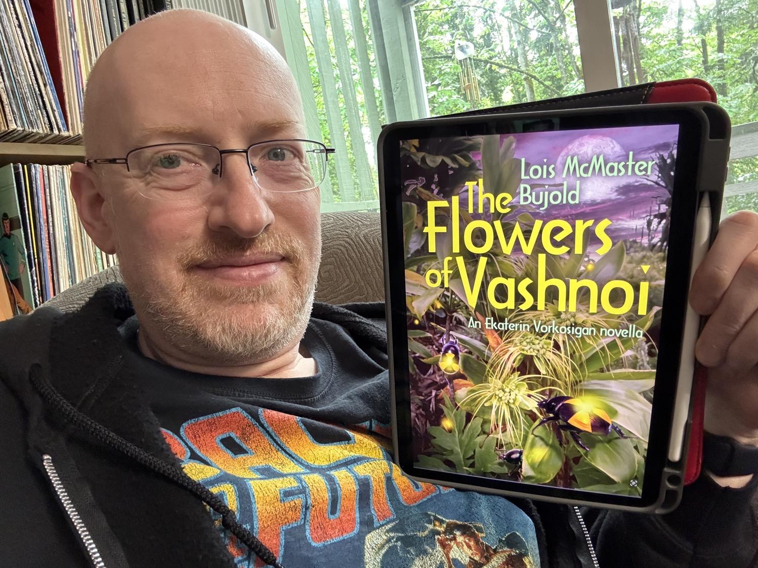 Me holding The Flowers of Vashnoi on my iPad.