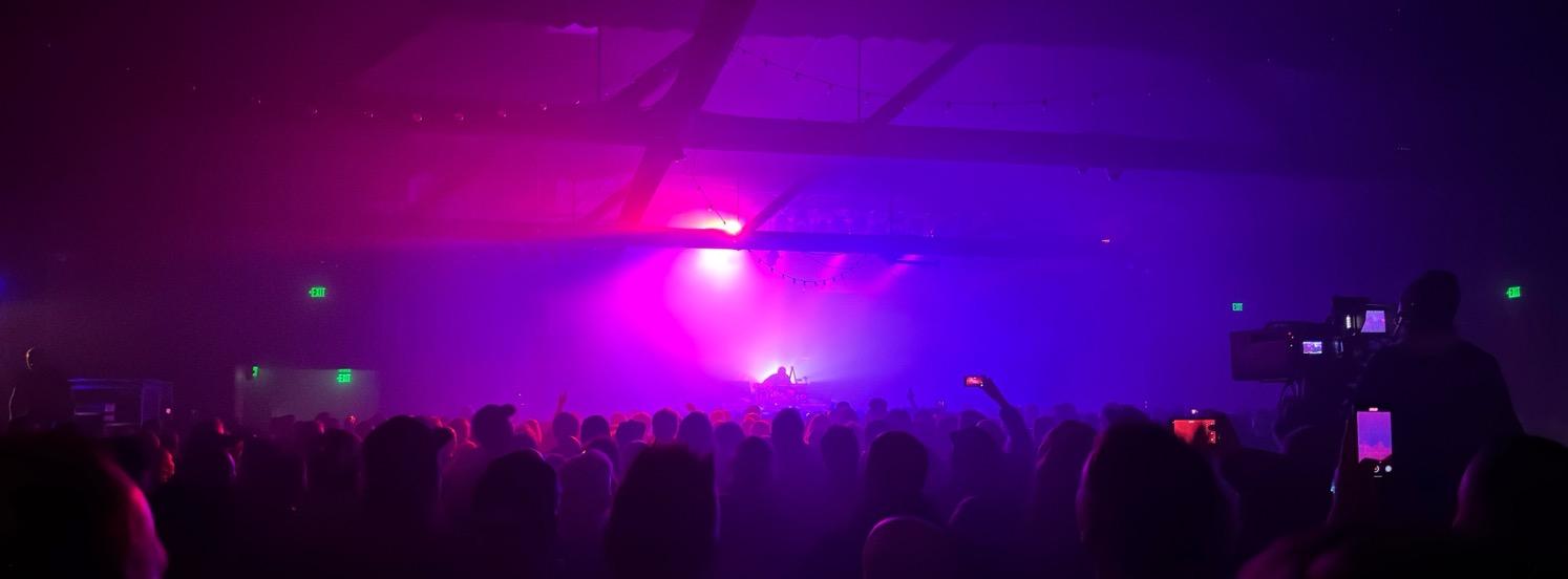 Underworld performing, list all in purples, blues, and magentas.