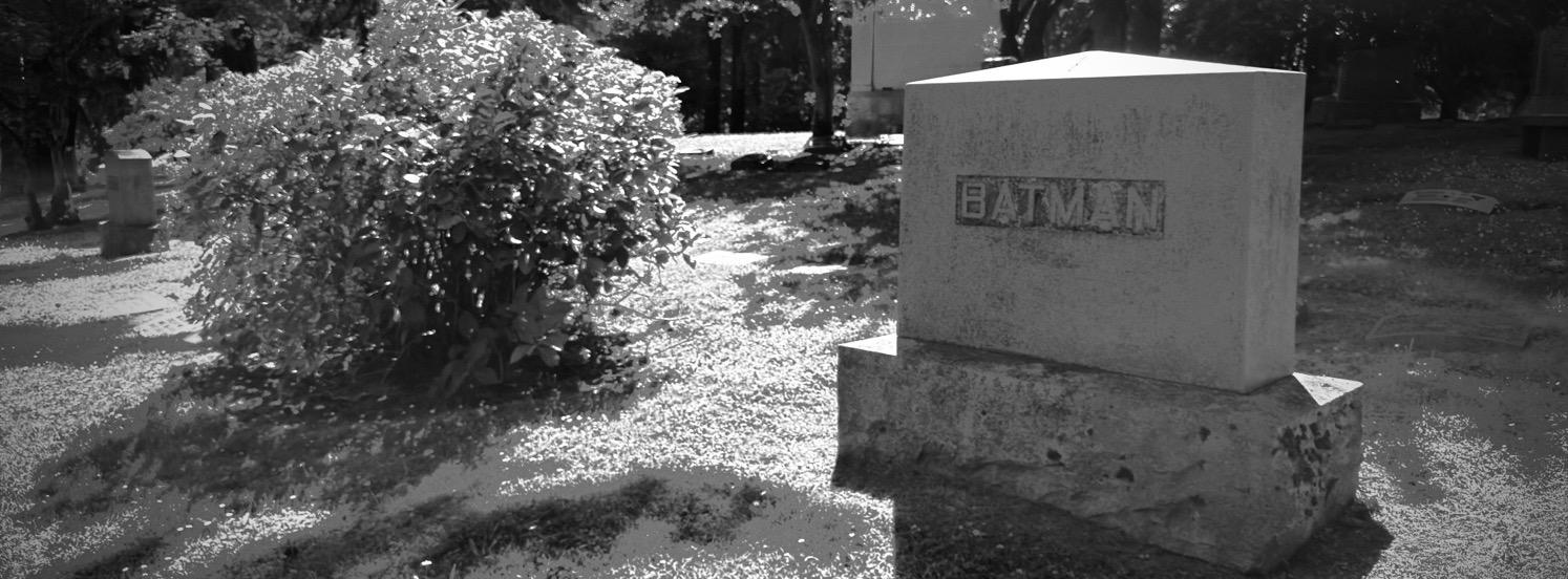 IMG_4472.jpeg Black and white image of a gravestone that just says Batman.
