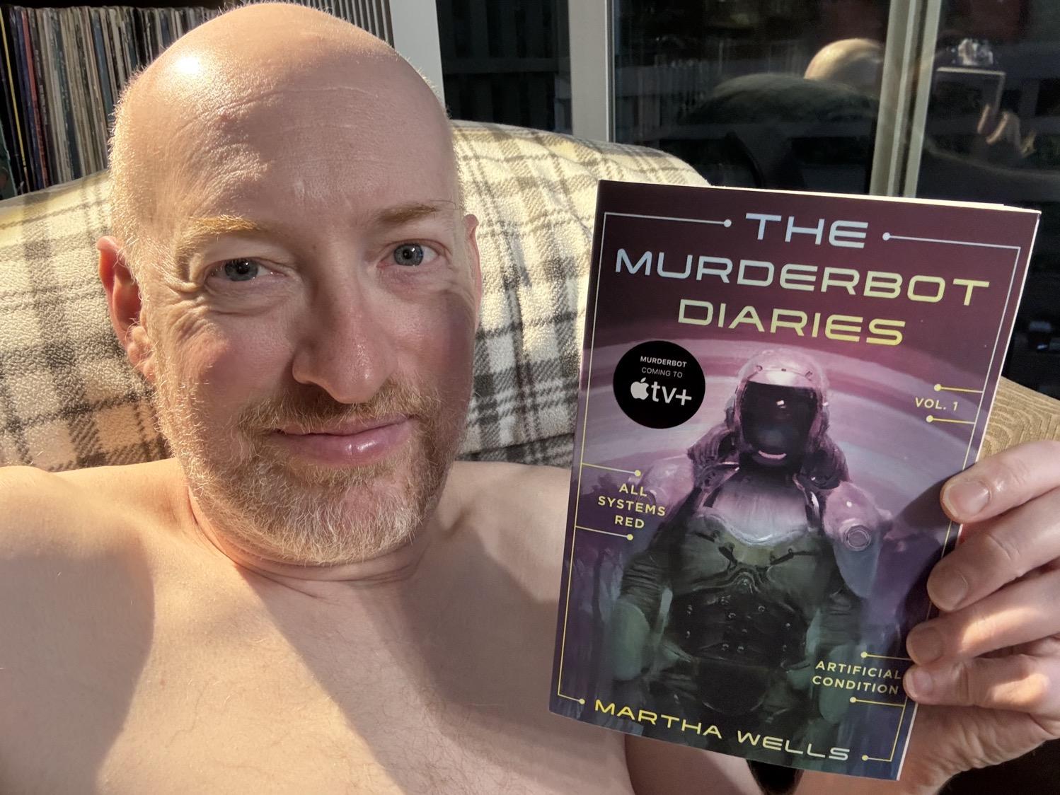 Me holding The Murderbot Diaries Vol. 1