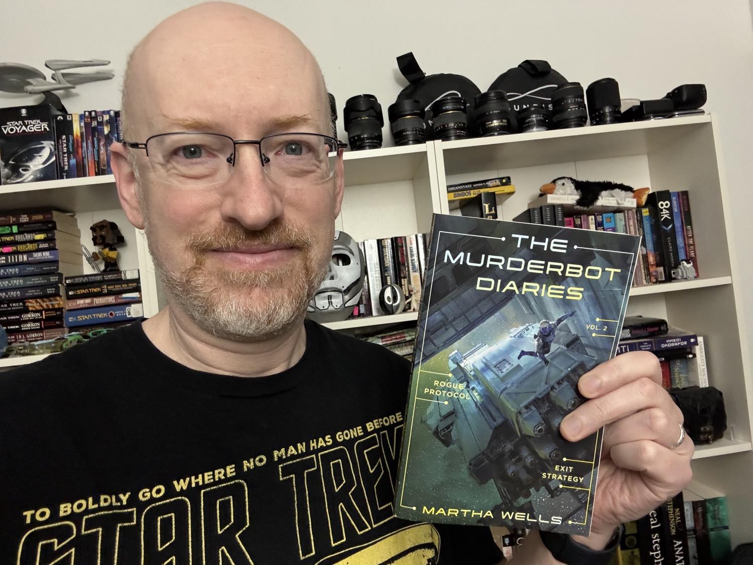 Me holding The Murderbot Diaries Vol. 2