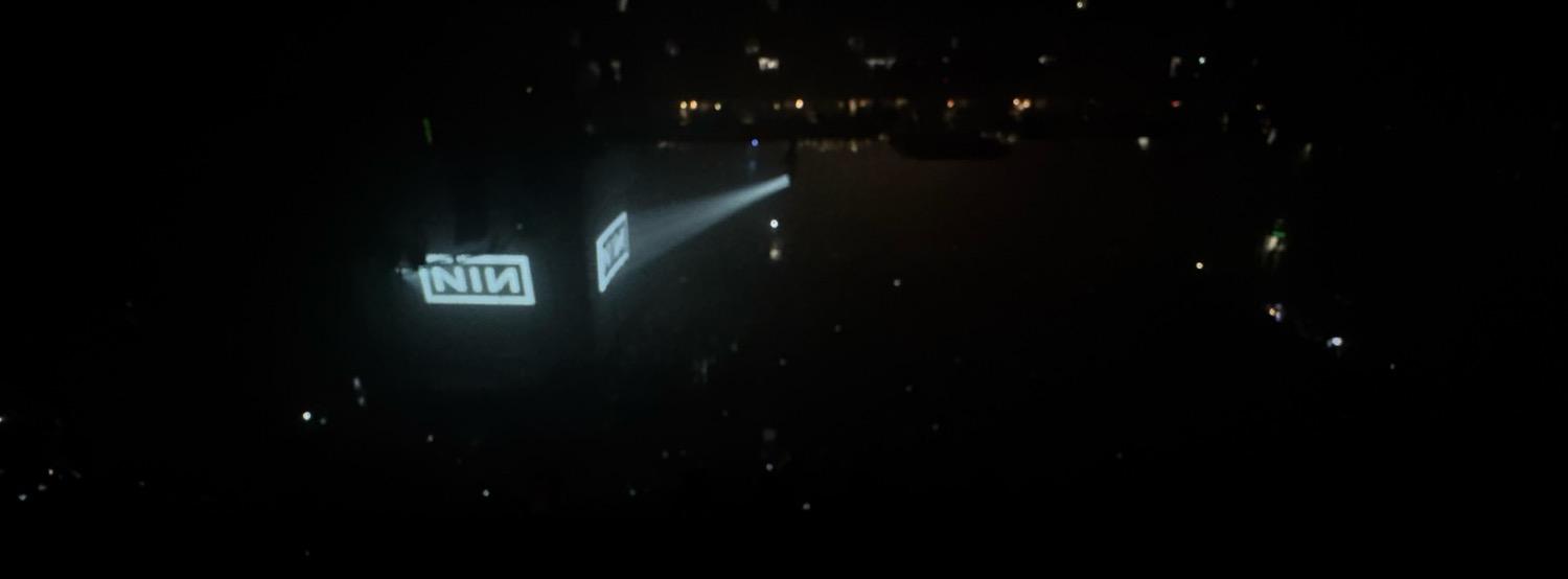 IMG_4678.jpeg The arena dark at the end of the show, save for the NIN logo projected on the screens around a black stage.