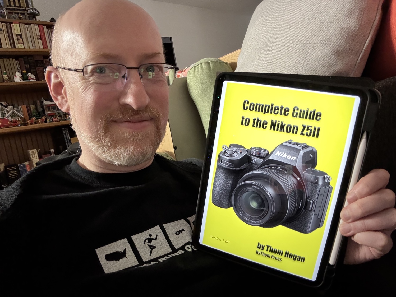 Me holding The Complete Guide to the Nikon Z5II on my iPad