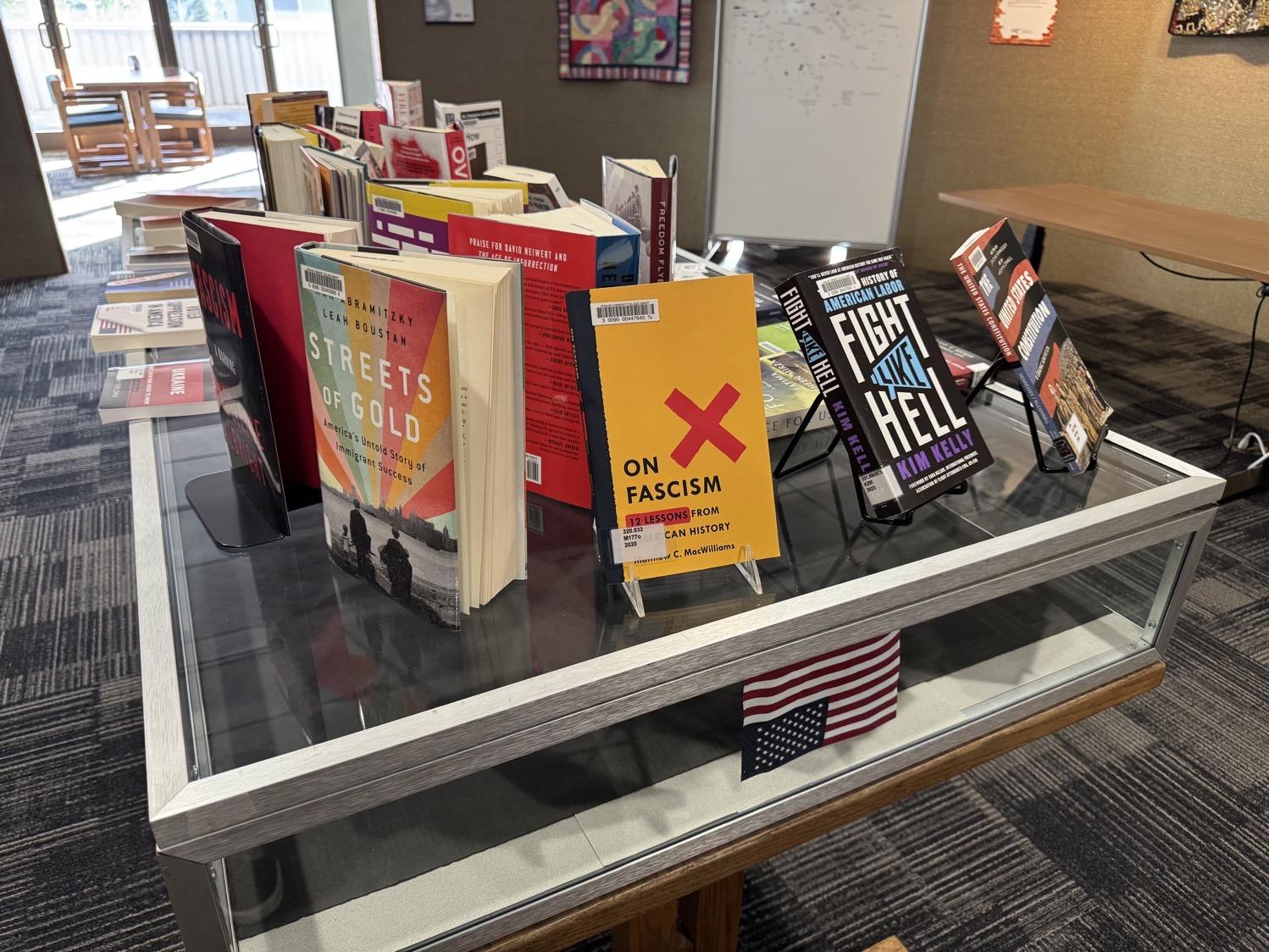 IMG_5583.jpeg A display of books in the college library, including titles like Fascism: A Warning, On Fascism: 12 Lessons from American History, Fight Like Hell: The History of America Labor, and The United States Constitution.