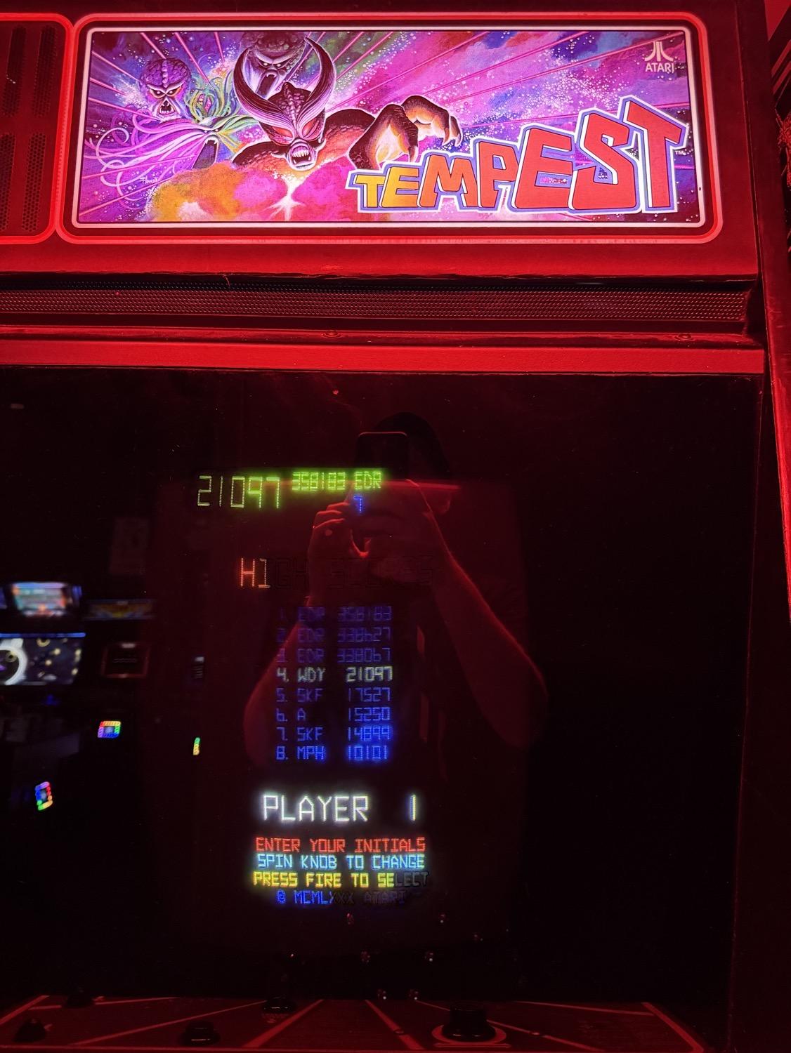 A Tempest arcade video game cabinet showing the post-game high score initial entry screen, with position number four highlighted with the letters W, D, and Y selected.