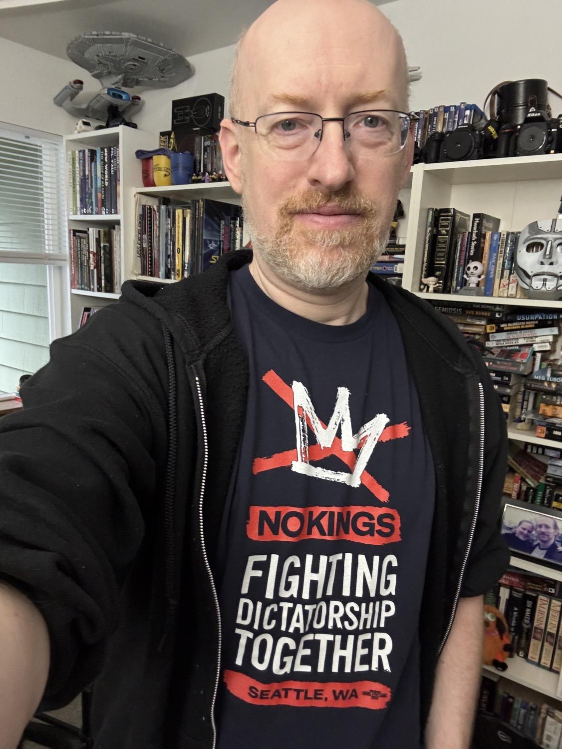 Me wearing a No Kings shirt with the organization logo and the text, 'No Kings: Fighting dictatorship together'.