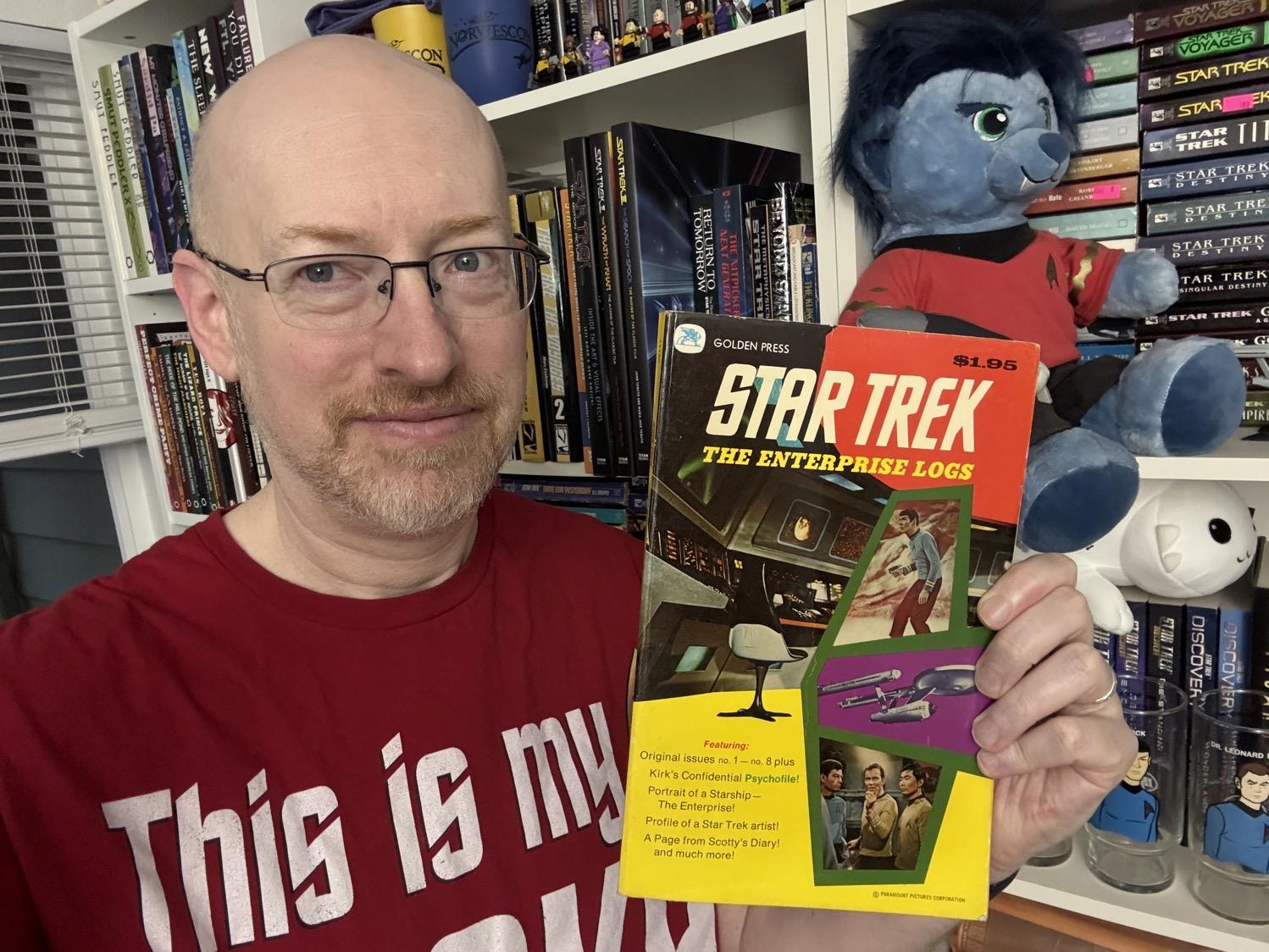 Me holding The Enterprise Logs