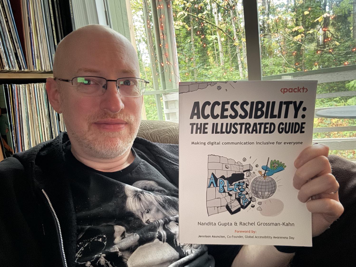 Me holding Accessibility: The Illustrated Guide.