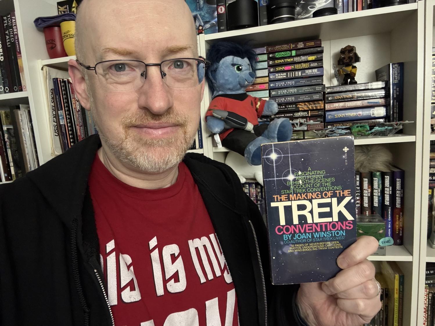 Me holding The Making of the Trek Conventions.